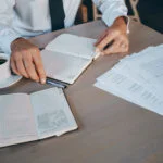 Startup founder reviewing legal documents and growth plan to structure equity and IP for long-term funding