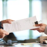 Two life sciences startup advisors reviewing a legal and financial growth plan to strengthen the company’s foundation before seeking investment