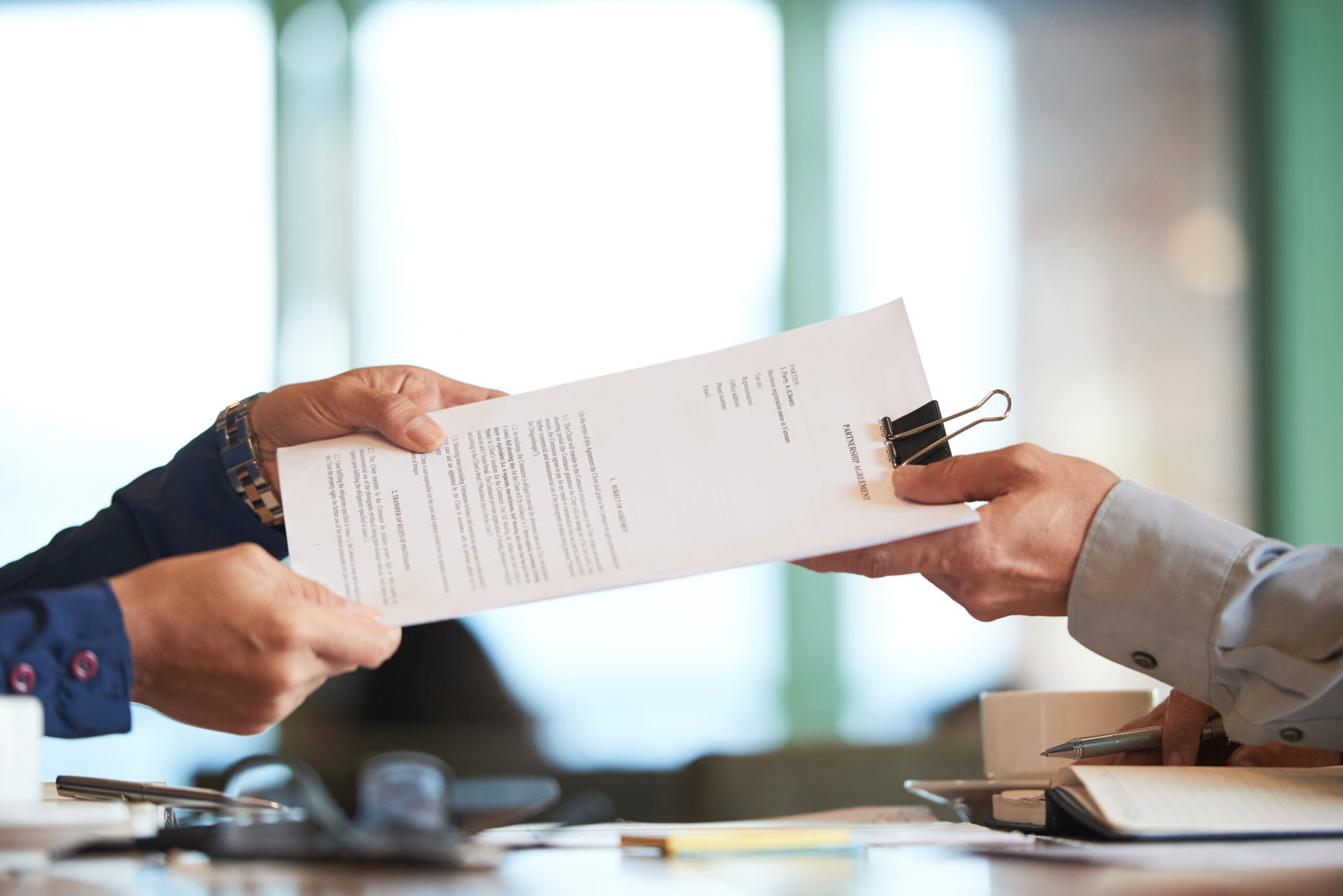 Two life sciences startup advisors reviewing a legal and financial growth plan to strengthen the company’s foundation before seeking investment