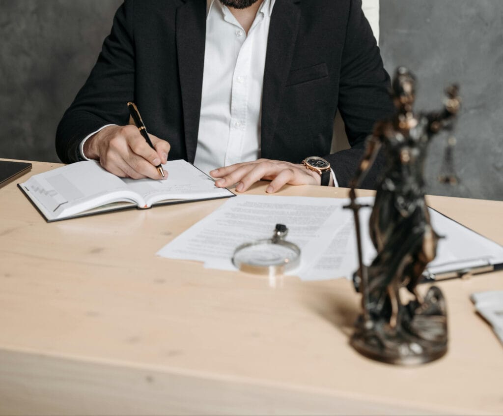 Lawyer sitting at the desk with legal papers.